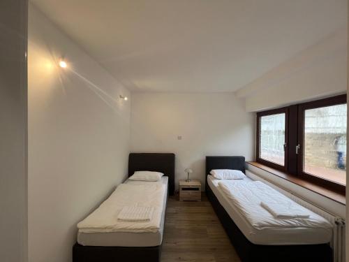 Ένα ή περισσότερα κρεβάτια σε δωμάτιο στο Kaune Apartments