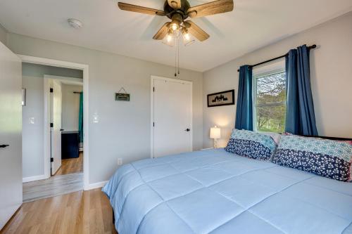una camera con letto blu e ventilatore a soffitto di 8 Mi to Jay Peak Resort Scenic Retreat with Deck a North Troy