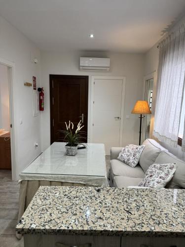 a living room with a couch and a table at Apartamentos La Gruta de Aracena con vistas in Aracena