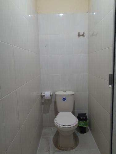 a bathroom with a white toilet in a stall at Mirador del Río in Honda
