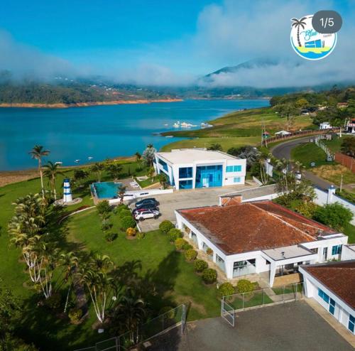 an aerial view of a house and the water at Hotel Blue Palace in Calima