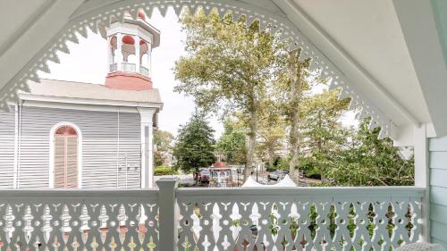 a porch with a white fence and a tower at The Ocean Loft At Kings in Cape May