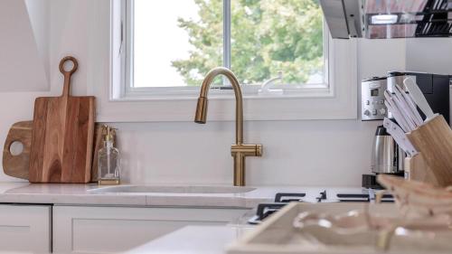 a kitchen counter with a sink and a window at The Ocean Loft At Kings in Cape May