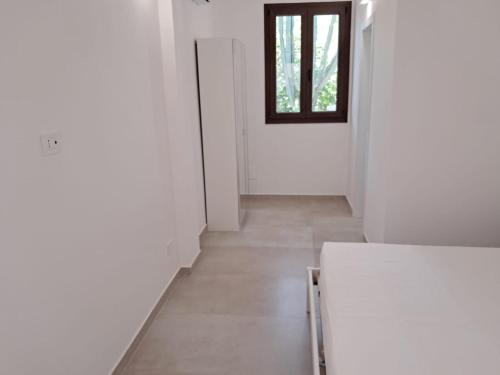 a white hallway with a door and a window at Agriturismo Tenuta La Siesta in Gallipoli
