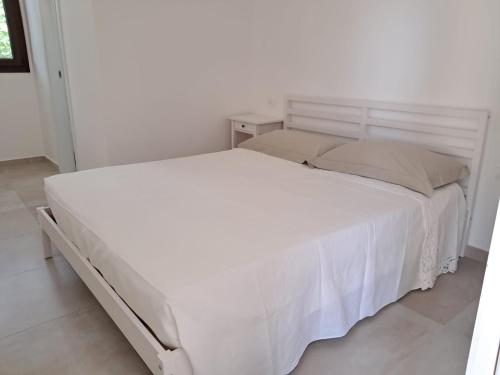 a large white bed in a white bedroom at Agriturismo Tenuta La Siesta in Gallipoli