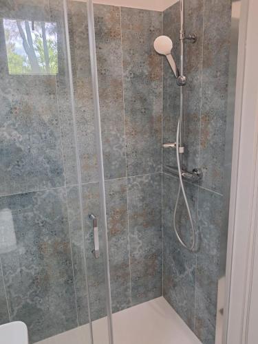 a bathroom with a shower with a glass door at Agriturismo Tenuta La Siesta in Gallipoli