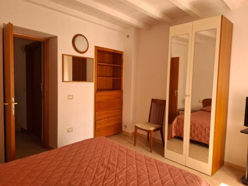a bedroom with a bed and a mirror at Sa Festa Manna in Guspini