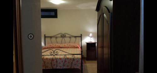 a bedroom with a bed and a lamp on a table at Casa Toto' in Alezio
