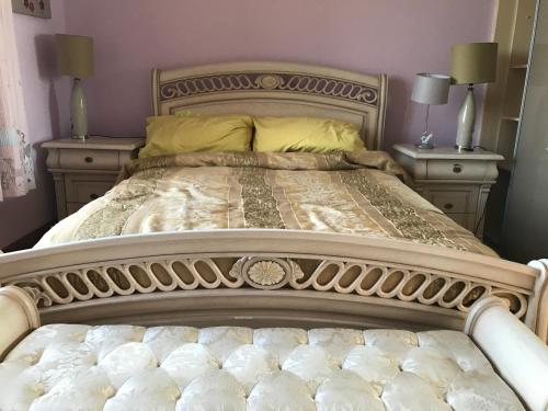 a large bed with two nightstands and two lamps at Serene Luxurious Haven with Sea Views Letterkenny Rooms in Letterkenny