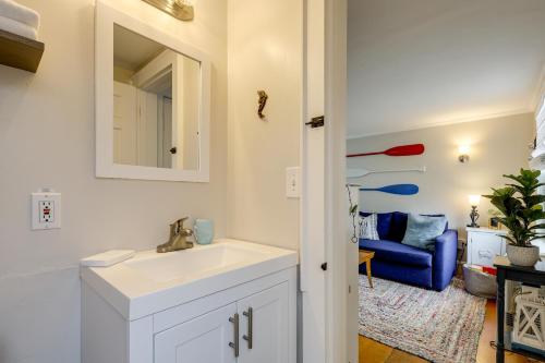a bathroom with a sink and a blue couch at 1 Mi to Ferry Sea Street Cottage in Hyannis in Hyannis