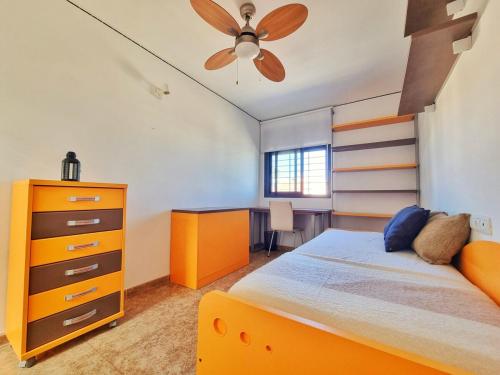 a bedroom with a bed and a dresser and a desk at Dúplex ENCANTOS DEL CABO, Retamar, Cabo de Gata in Retamar