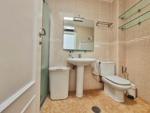 a bathroom with a sink and a toilet and a mirror at Dúplex ENCANTOS DEL CABO, Retamar, Cabo de Gata in Retamar