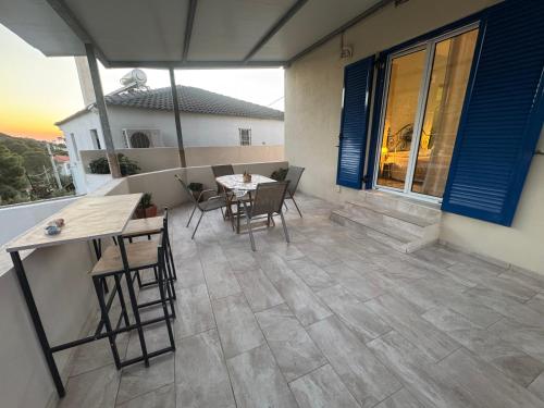 a patio with a table and chairs on a house at Detached House KATAFIGI in Palaiá Fókaia