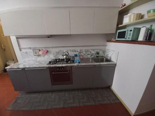 a small kitchen with a sink and a stove at Dal Teatro - Imola Centro in Imola