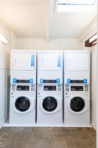 four washers and dryers in a laundry room at Camp Trinidad RV Resort in Trinidad
