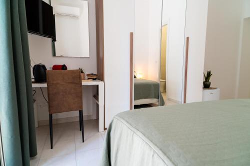 a bedroom with a bed and a desk and a bed at Casa Pirandello in Terracina