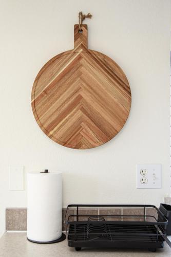 a wooden plate hanging on a wall above a bed at Camp Trinidad RV Resort in Trinidad
