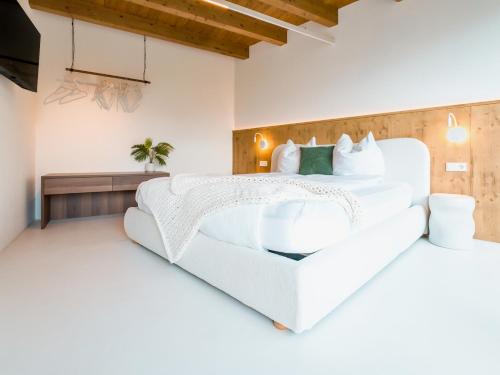 a white bedroom with a large white bed at PENTHOUSE N`4 - Stylish Apartment with Rooftop Whirlpool Access in Tyrol, presented by AlpenLuxus in Kramsach
