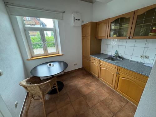 a small kitchen with a table and a window at Villa Theresia in Benediktbeuern