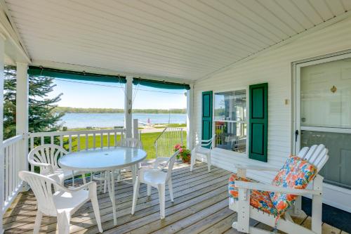 a porch with a table and chairs and a view of the water at Tallman Lake Access Family-Friendly Home with Dock! in Fountain