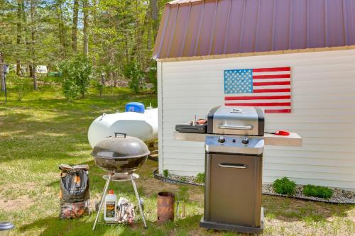 a grill and a smoker next to a house at Tallman Lake Access Family-Friendly Home with Dock! in Fountain