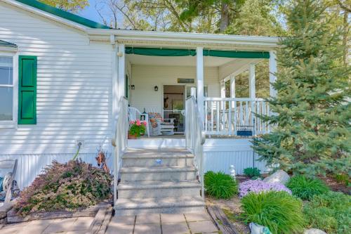 a white house with stairs leading to a porch at Tallman Lake Access Family-Friendly Home with Dock! in Fountain