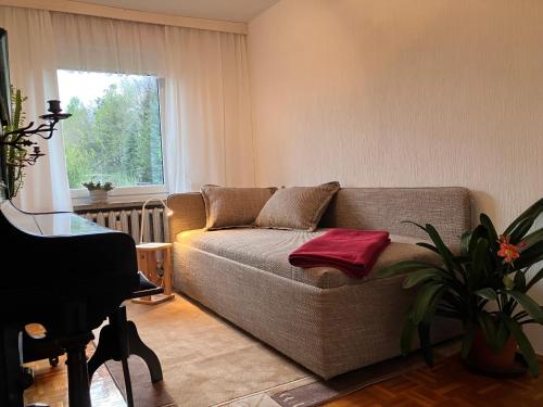 a living room with a couch and a window at Ferienwohnung Hans in Girbigsdorf