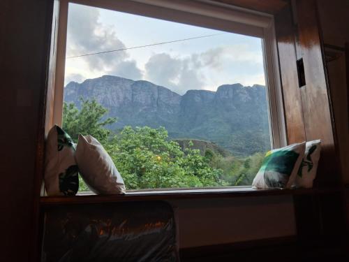 a window with a view of a mountain view at Pousada das Nascentes in Catas Altas
