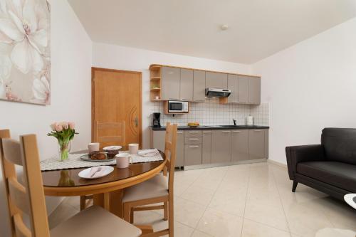 a living room and kitchen with a table and a couch at Apartments Kvarner 2 in Malinska