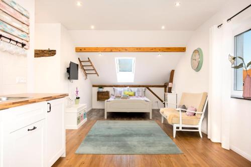 a kitchen and living room with a couch and a table at Ferienwohnung Kunterbunt Eckernförde in Eckernförde