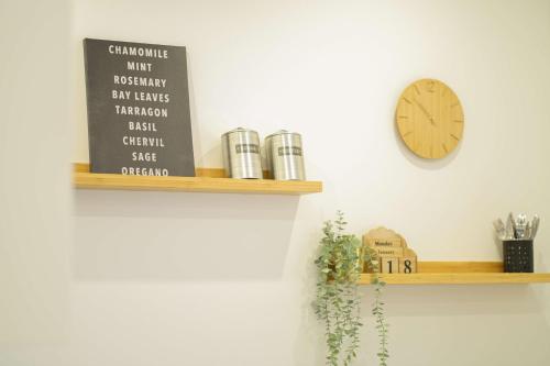 a clock on a wall next to a shelf at Palstek in Eckernförde