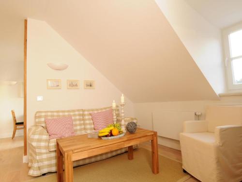 a living room with a couch and a table at Ferienwohnung Nr 8 im Gutshaus Zicker auf Rügen in Garz-Rügen