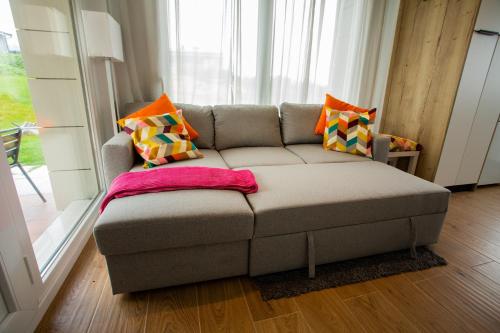 a couch with pillows on it in a living room at Sopela Kosta Fun in Sopelana