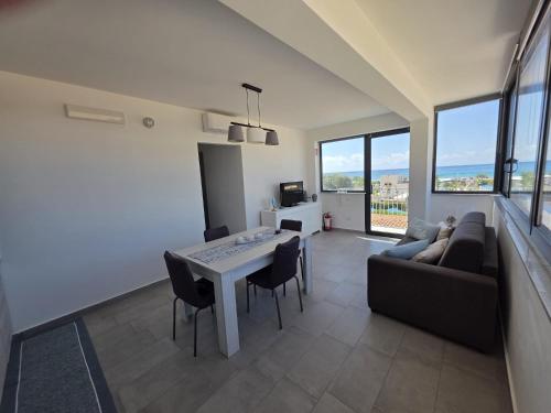 a living room with a table and a couch at A Casa di Angela in Capaci