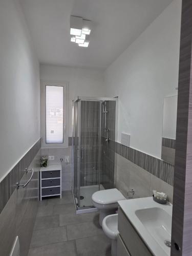 a bathroom with a shower and a toilet and a sink at A Casa di Angela in Capaci