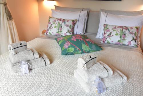 a bed with towels on top of it at Ioni Home in Tsagarada