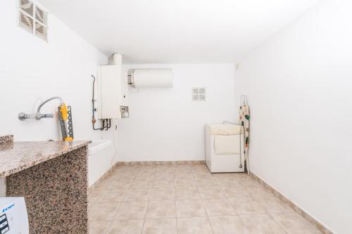 a kitchen with a refrigerator and a tile floor at Apt B Algemesi Moraira in Moraira