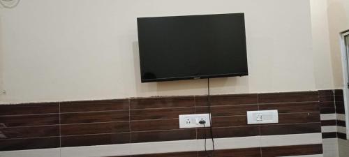 a flat screen tv hanging on a wall at New Gayatri place Near by prem mandir in Dānītola