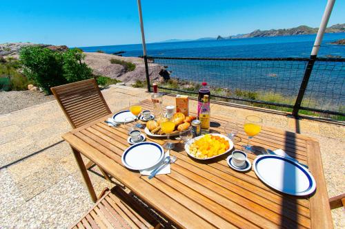 a table with food and drinks and a bowl of fruit at Terraza del Mediterráneo - By Aloha Palma in Calabardina