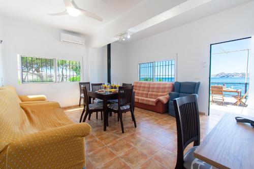 a living room with a table and chairs and a couch at Terraza del Mediterráneo - By Aloha Palma in Calabardina
