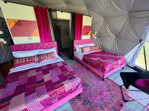 a room with two beds and a tent at DayDreamer Domes in South Haven