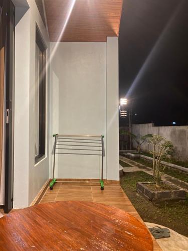 a bench sitting on a porch at night at Lombok Grace Bungalows in Tetebatu