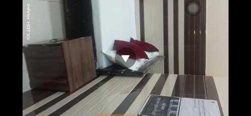 a room with a table with a book and a lamp at New Gayatri place Near by prem mandir in Dānītola
