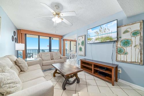 a living room with a couch and a table at Phoenix 2 Unit 2034 in Orange Beach