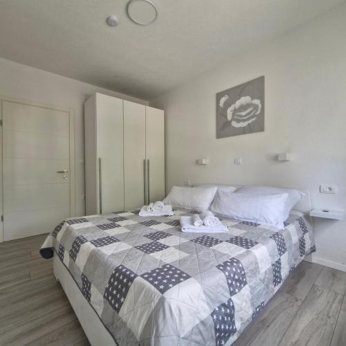 a bedroom with a bed with towels on it at Vila Natasa Apartment 4 near Plitvice in Vrhovine