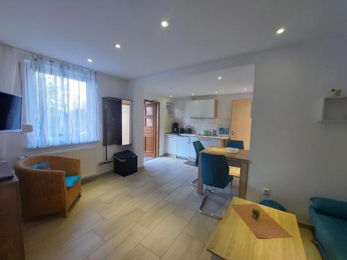 a living room with a table and a kitchen at Ferienquartier T5 Bahnhofstraße 6 in Trassenheide