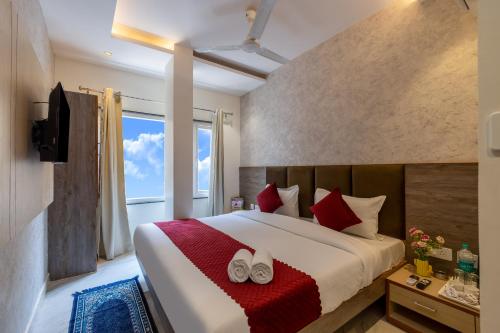 a bedroom with a large bed with red pillows at Hotel Stay House Inn 3 Mints walk from New Delhi Railway station,5 Mints from Metro in New Delhi