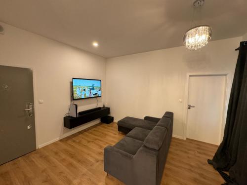 a living room with a couch and a flat screen tv at Lovely 2 bedroom near city centre Bratislava in Brenner
