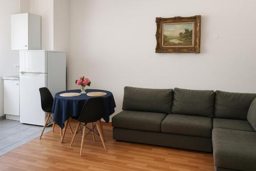 a living room with a couch and a table at Tiny apartment near the airport in Ponta Delgada