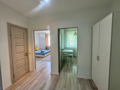 an empty room with a door and a bedroom at ЖК Времена года Весна Кабанбай Батыра 46 in Taldykolʼ